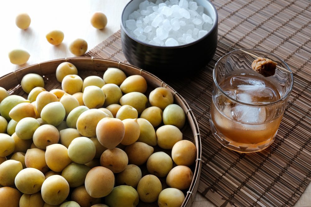 fresh,plums,,rock,sugar,and,plum,wine,in,a,clear